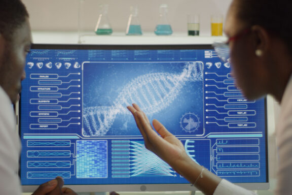 Scientist examines DNA models in modern Genetic Research Laboratory.