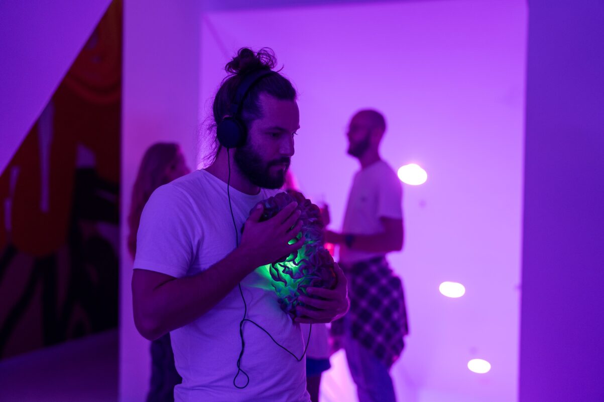 Man holding a regenerative implant as an art installation at a festival