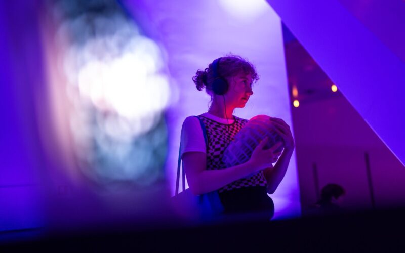 Art and medicine combine. Woman holds organ at festival.