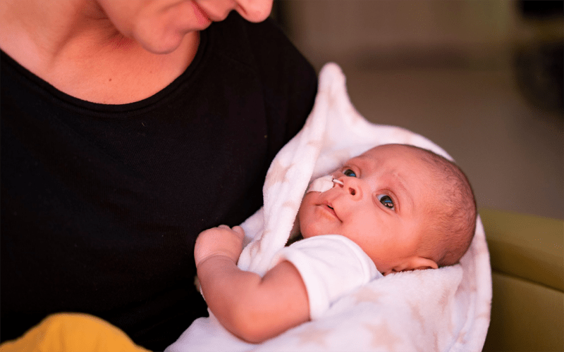 Mother carrying a baby