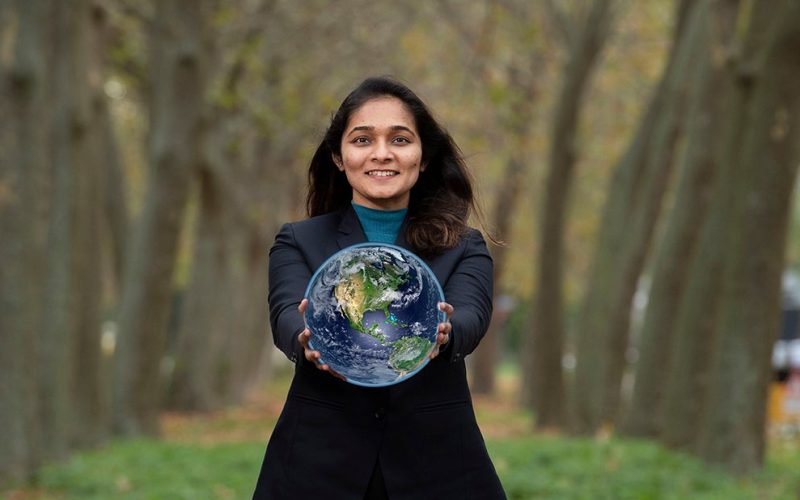 Lekha Rathod holding a world globe