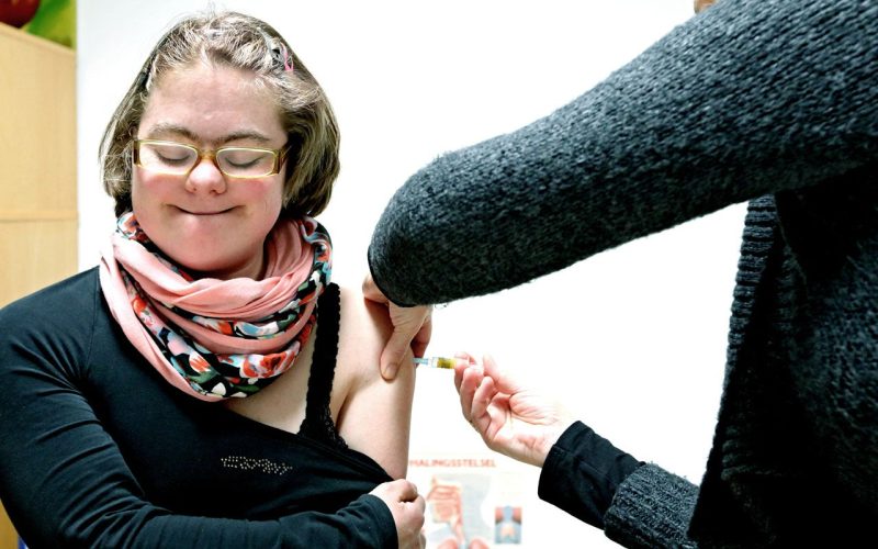 Girl with Down Syndrome getting a vaccine