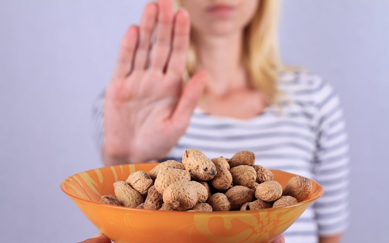 Hand rejecting a bowl of peanuts