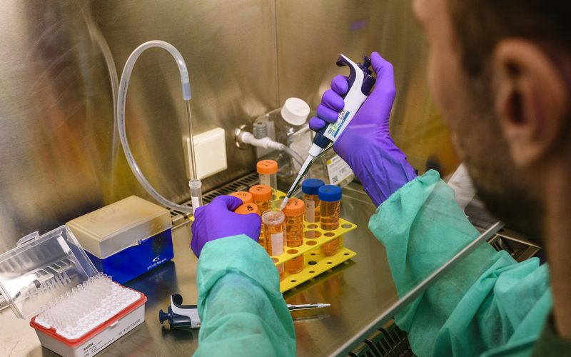 A researcher with a pippet.