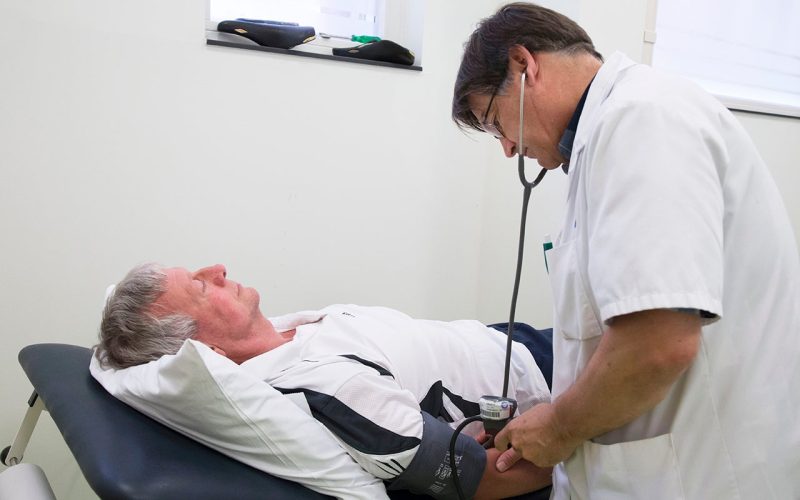 Health care provider measuring the blood pressure of a patient