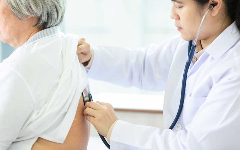 Doctor listening to the lungs of a patient