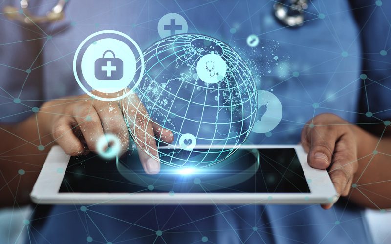 A person taps his finger on the ipad he is holding