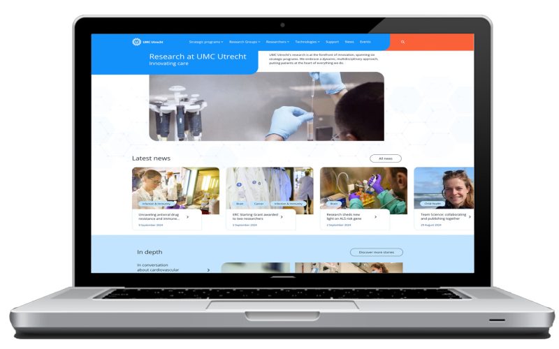 A laptop with the research website displayed.