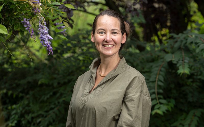 een vrouw glimlacht naar de camera